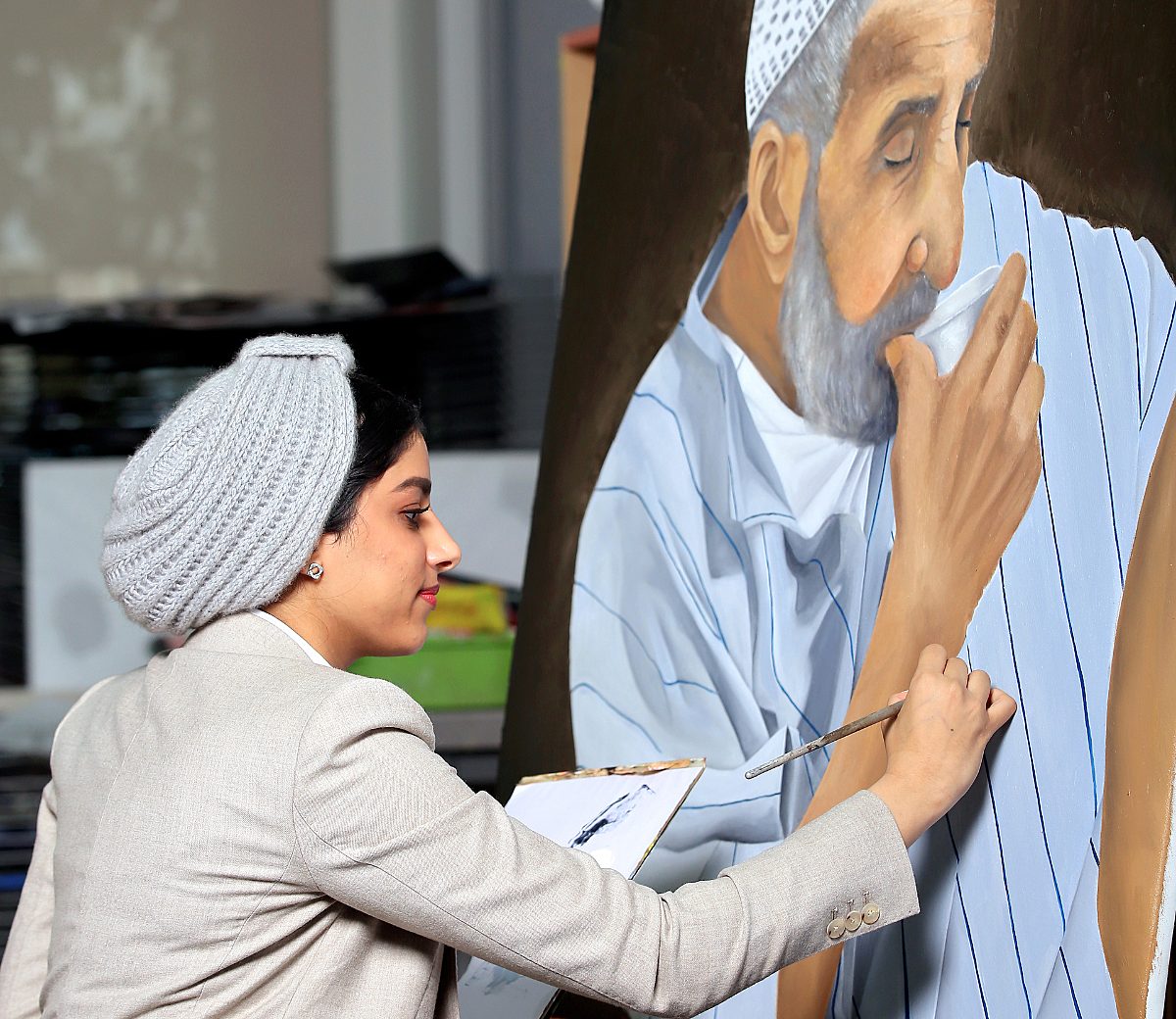 Visual arts pupil working on a large painting