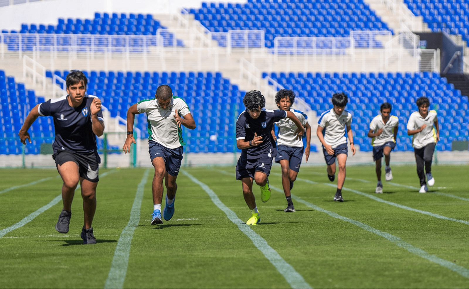 Senior pupils sprinting during athletics training
