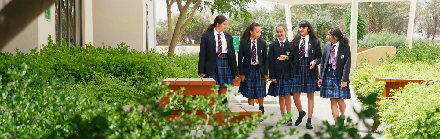 Senior pupils walking through the campus gardens
