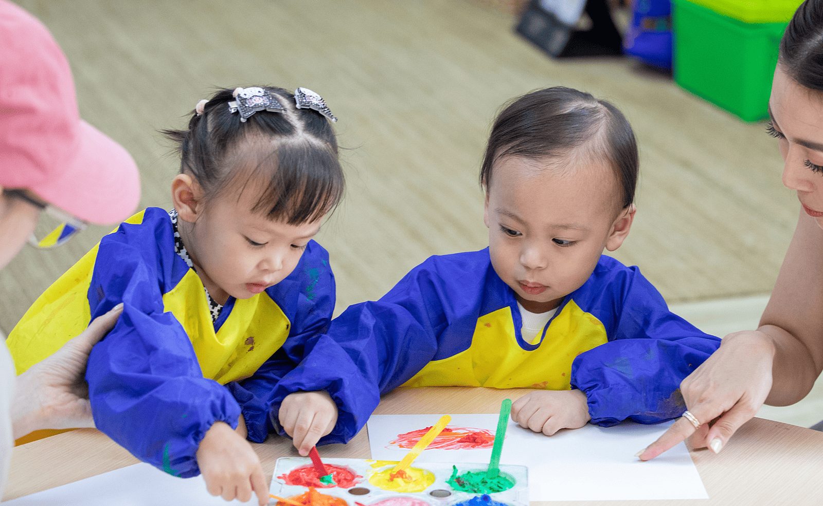 Toddlers painting at an Early Years session