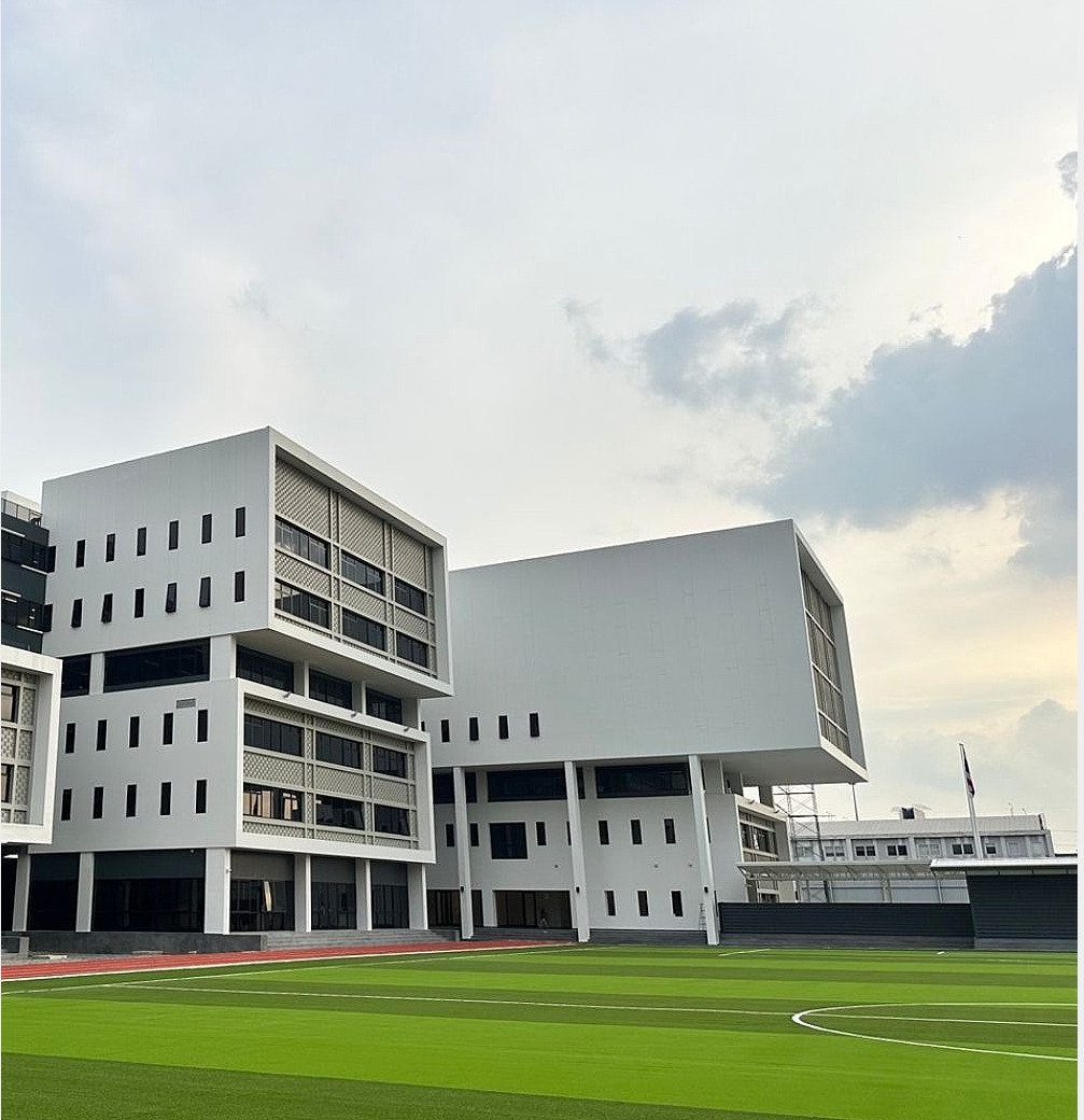 Teaching blocks beside the sports field on the Vibhavadi campus