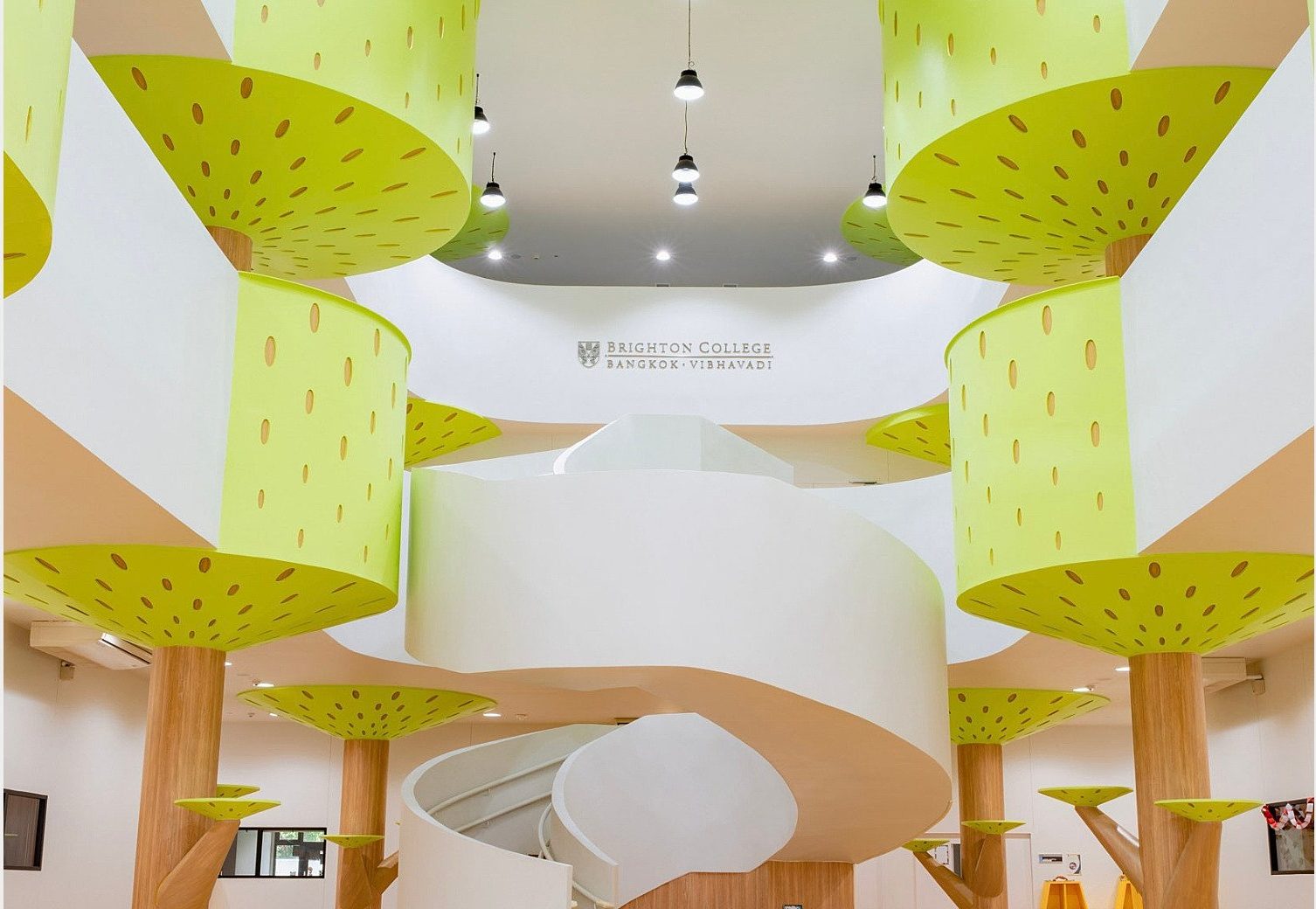 Early Years atrium with tree-themed decor and a spiral staircase