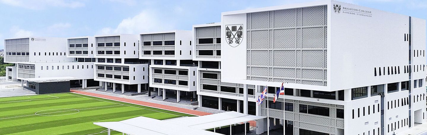 Aerial view of the main building and sports field at Brighton College Bangkok Vibhavadi