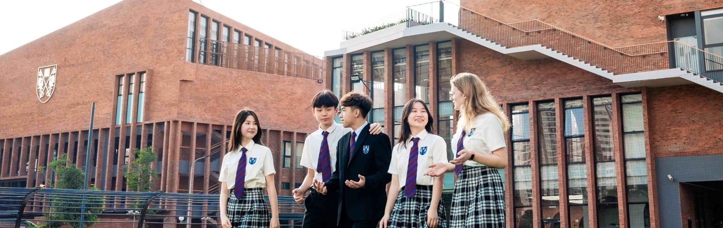 Pupils walking across the campus lawn at Brighton College Vietnam